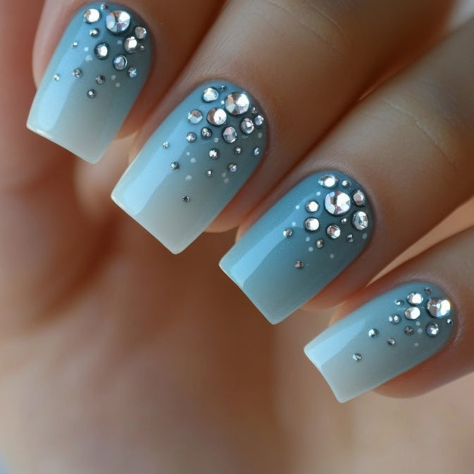 nail design with blue and white colors and rhinestone accents