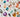 A variety of colored gems are arranged on a white surface