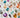 A variety of colored gems are arranged on a white surface