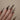 Stiletto nails with crystals in golden shadow colour
