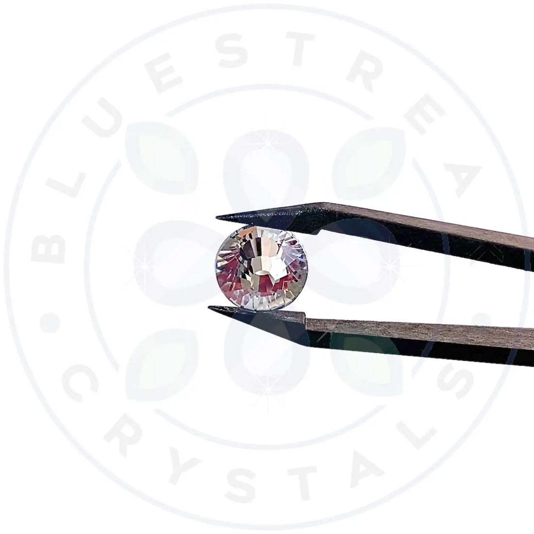 Estella flatback crystal sparkling in tweezers with the Serinity logo in the background