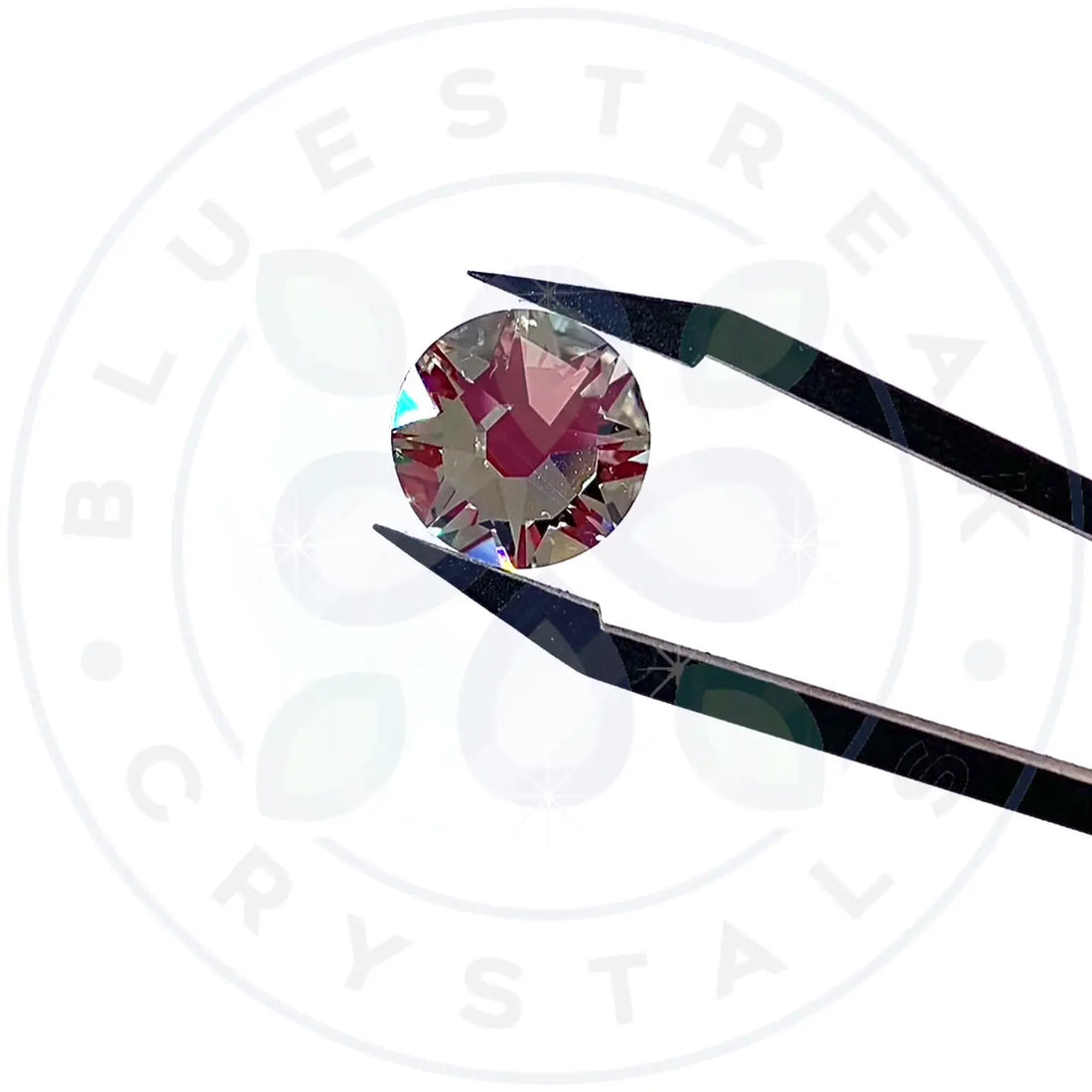 swarovski flatback crystal sparkling in tweezers with the Serinity logo in the background